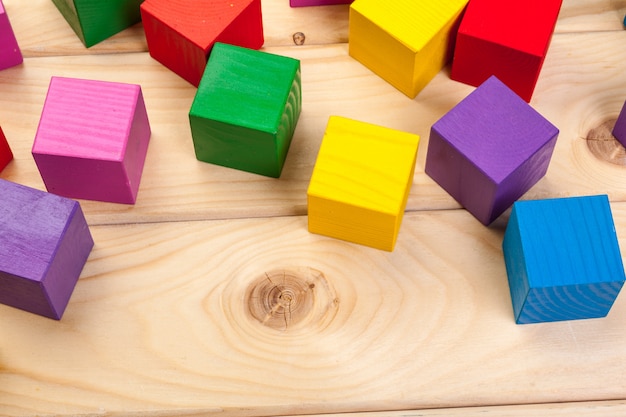 Colorful wooden cubes on wooden table