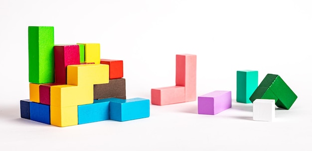 Colorful wooden elements of puzzle construction formation\
concept kids logical game for problem solving skills\
development