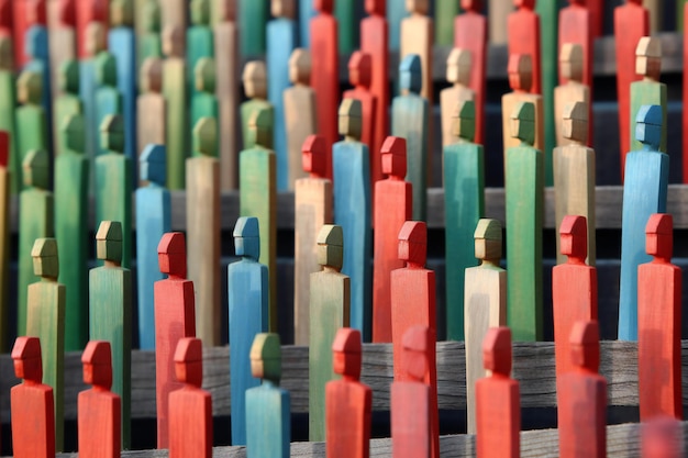 Colorful wooden figures as a background closeup Selective focus