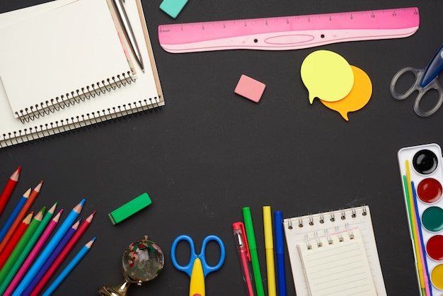 Colorful wooden pencils, scissors, notepads and paint for drawing