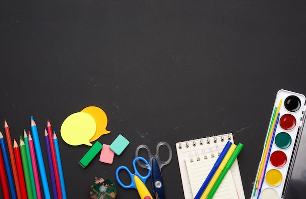 Colorful wooden pencils, scissors, notepads and paint for drawing