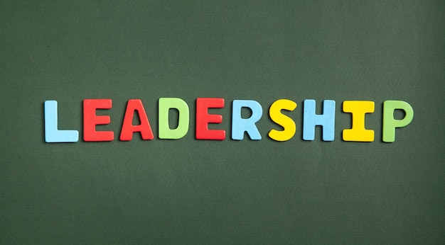 Colorful word Leadership on green background.