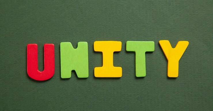 Photo colorful word unity on green background