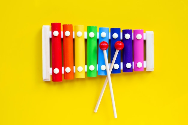 Photo colorful xylophone on yellow isolated.