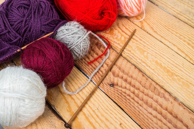 Colorful yarn balls on wood