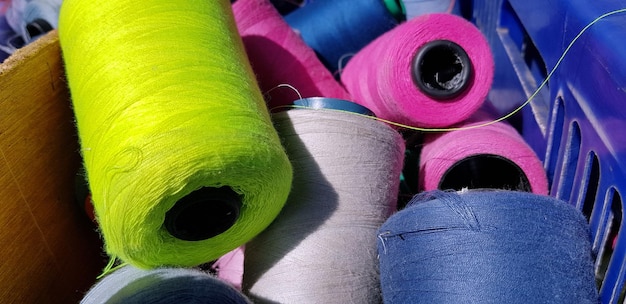 Colorful yarn on spool yarn on tube cotton wool linen thread orange