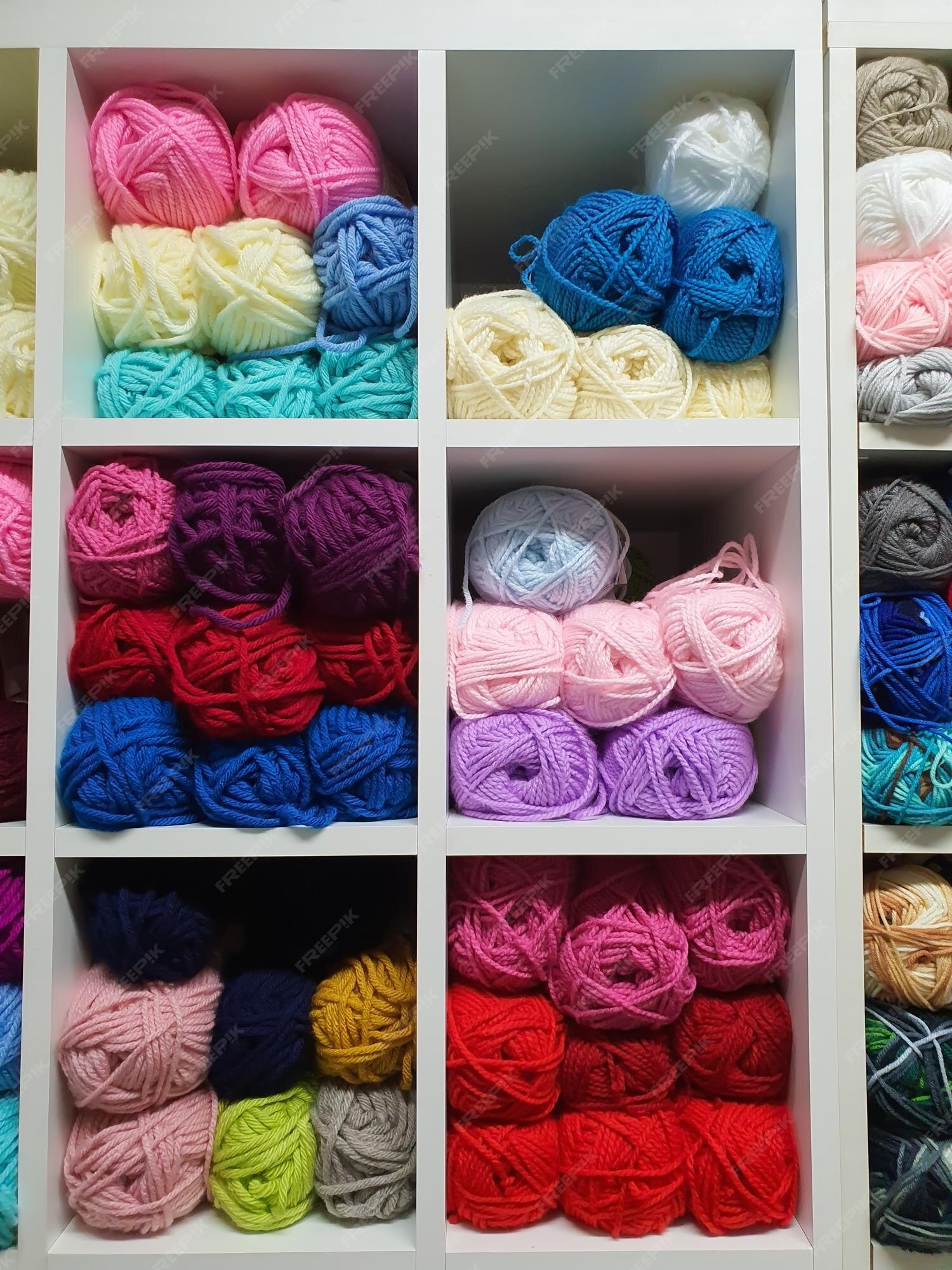 Premium Photo  Colorful yarns of wool for knitting on shelves in the  haberdashery shop knitwork handcraft concept