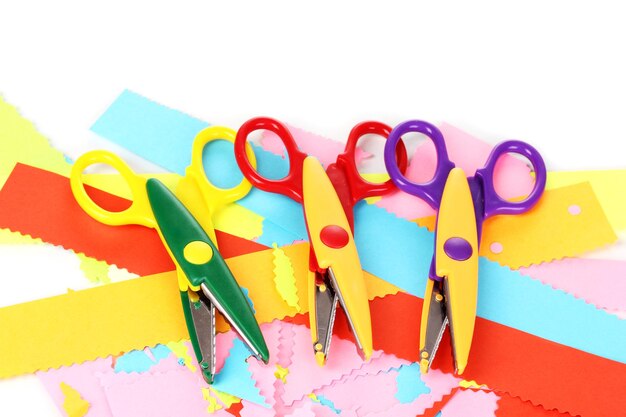 Colorful zigzag scissors with color paper isolated on white