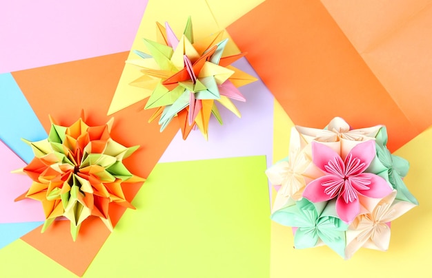 Colorfull origami kusudamas on bright paper background