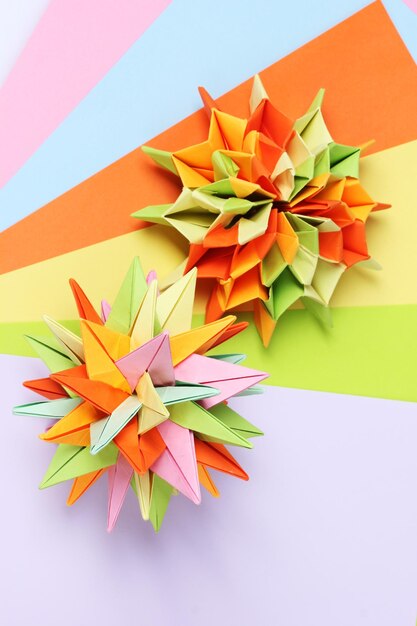 Colorfull origami kusudamas on bright paper background