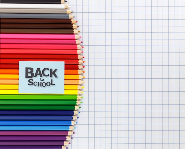 coloring pencils arrange in row on grid paper