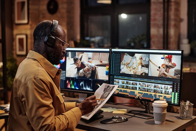 Photo colorist examining script at office