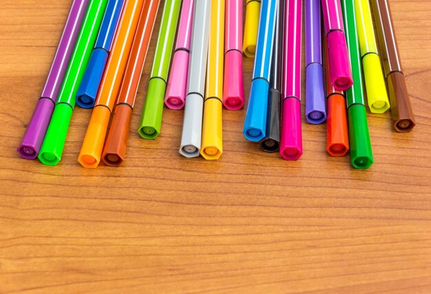 Colour markers on the wooden table Close up