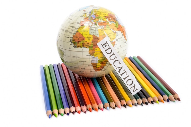 Colour pencils with globe and education note