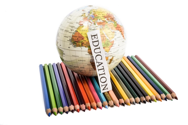 Colour pencils with globe and education note