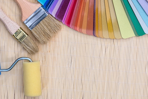 Colour samples with brushes on bamboo mat background