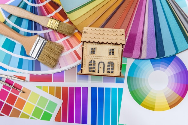 Colour swatch with wooden house model close up