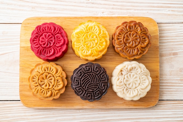 colourful Chinese moon cake with mixed flavour on wood plate