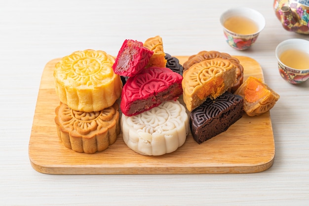 colourful Chinese moon cake with mixed flavour on wood plate