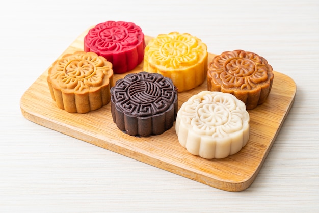 colourful Chinese moon cake with mixed flavour on wood plate