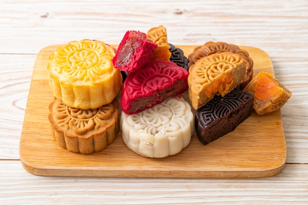 colourful Chinese moon cake with mixed flavour on wood plate