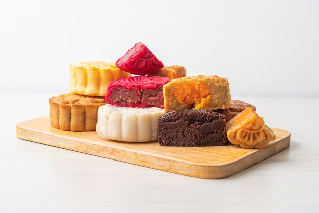 colourful Chinese moon cake with mixed flavour on wood plate