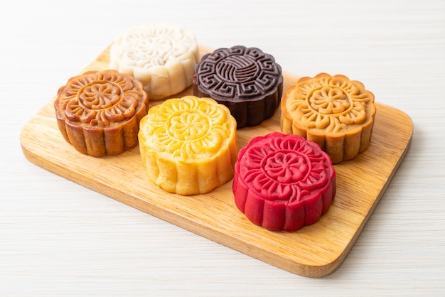 colourful Chinese moon cake with mixed flavour on wood plate