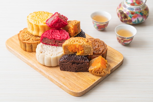 colourful Chinese moon cake with mixed flavour on wood plate