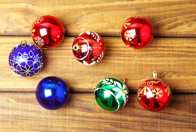 Colourful christmas bubbles on wooden background.