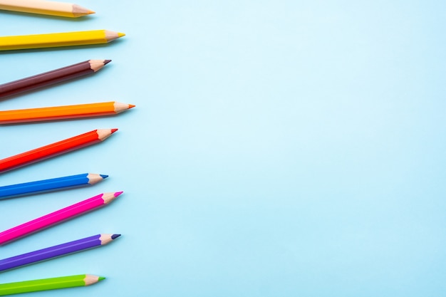 Photo colourful crayons or colour pencil set in range background