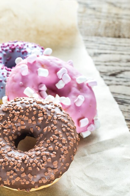 Colourful donuts on the baking paper