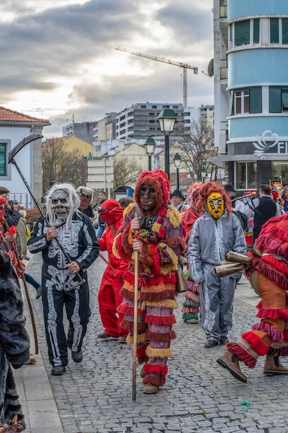 Colourful dressed masked men in the Carneval Carnival in Braganca Portugal Europa