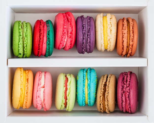 Colourful French Macaroons in box on modern table