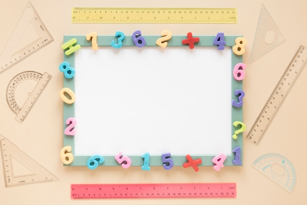 Photo colourful math numbers frame of white card top view