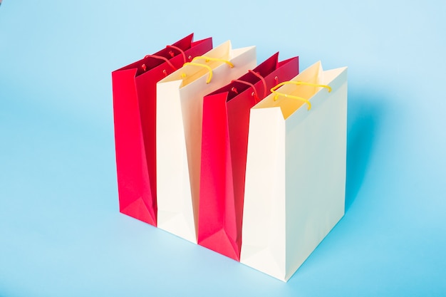 Colourful Paper shopping bags on blue