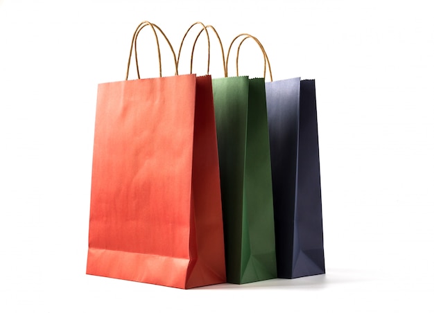 Colourful paper shopping bags on white background