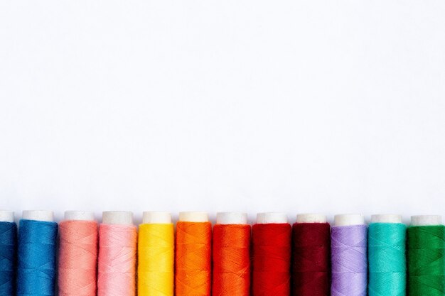 Colourful sewing threads on white