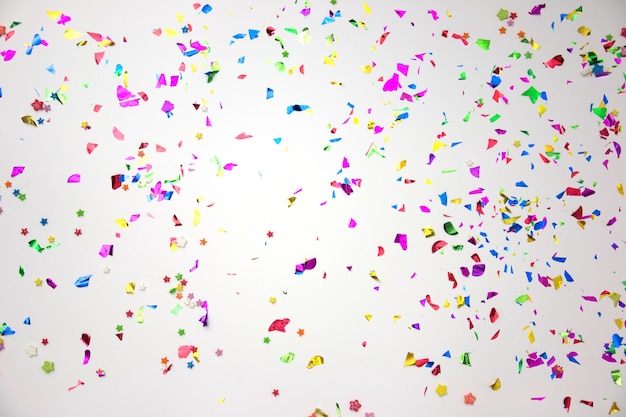 Colourful sparlking confetti on white background