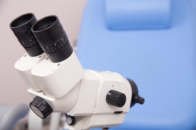 Photo colposcope closeup on the background of gynecological chair