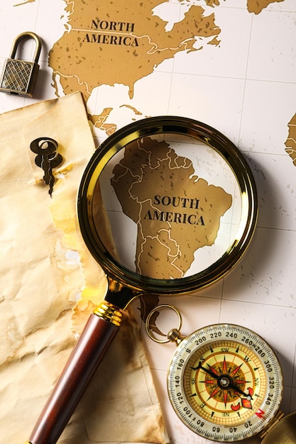 columbus day old compass with a magnifying glass on the map of america