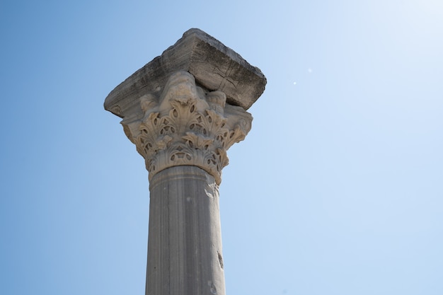 Column on a background of blue sky closeup sight