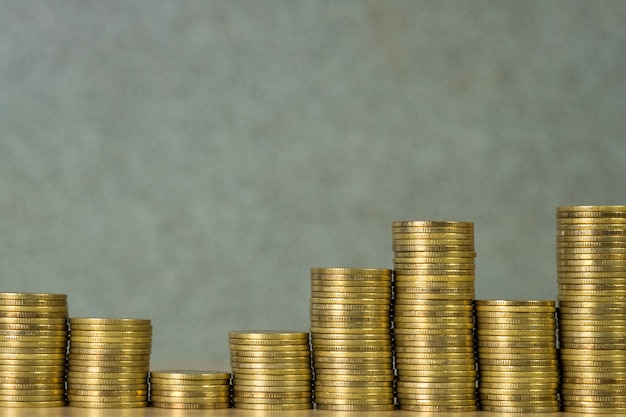 Columns of gold coins, piles of coins on working table, business banking and financial concept.