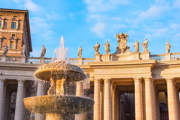 Columns in Saint Peter's Square Alexander VII city fountain evening sunset light Vatican