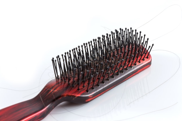 Photo comb and hair on white background