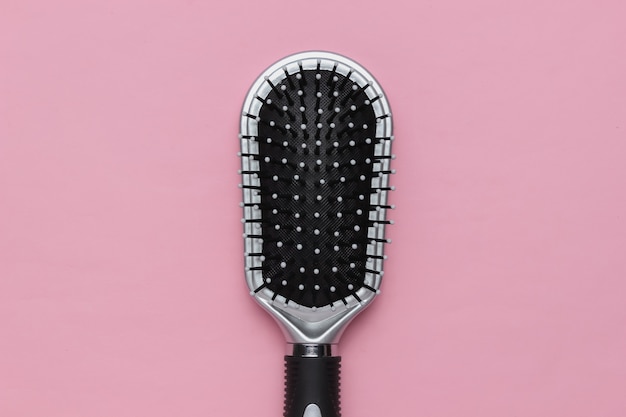 Comb on pink pastel background Beauty minimalistic concept