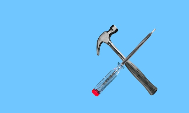 Photo combination hammer and screwdriver on blue background