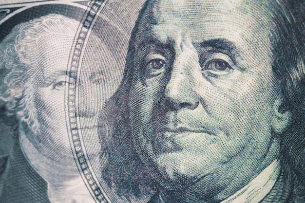 Photo combined image of benjamin franklin and george washington portraits on the us 100 and 1 dollar bill.