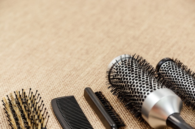 Combs and hairdresser tools on beige 