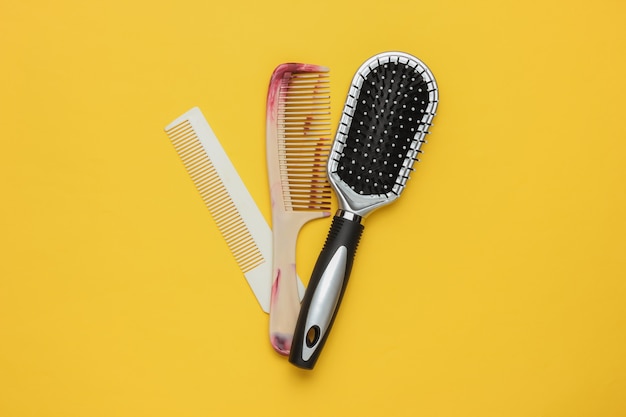 Photo combs on yellow background beauty minimalistic concept