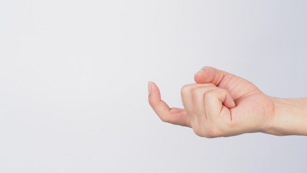 Photo the come hither hand sign on white background